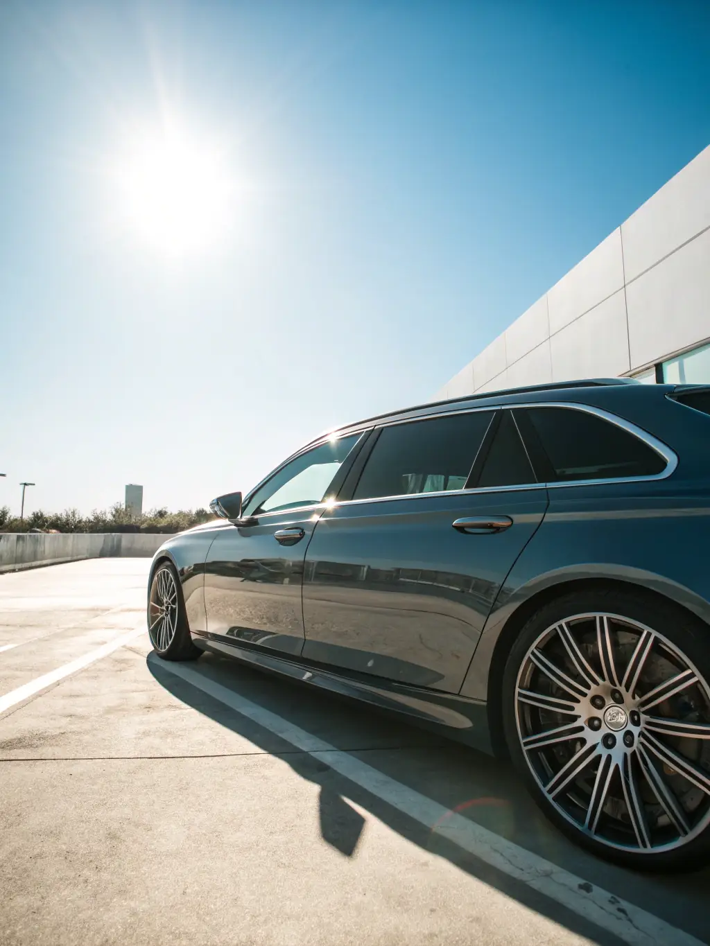 A professionally tinted car window, showcasing the sleek, dark tint and its seamless integration with the vehicle's design. The image should convey a sense of sophistication and UV protection.